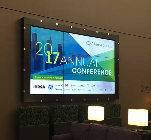 tv screen displaying the alliance chicago 2017 conference logo